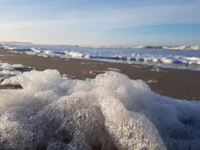 a pile of snow on a beach near the ocean at 5 person holiday home in Brovst-By Traum in Brovst