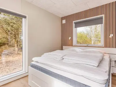 a bed in a room with a window at 5 star holiday home in Øster Assels-By Traum in Øster Assels