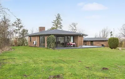 a house with a large lawn in front of it at Awesome Home In Roslev With Kitchen in Roslev