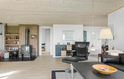 a living room with a couch and a fireplace at Awesome Home In Roslev With Kitchen in Roslev