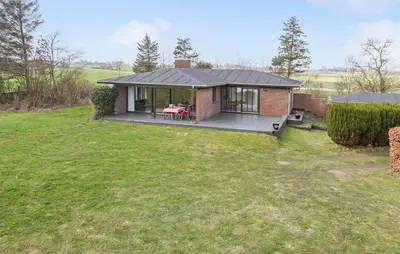 a small house with a porch and a lawn at Awesome Home In Roslev With Kitchen in Roslev