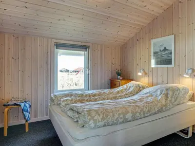 a bedroom with a bed in a room with a window at Holiday Home Emelia - 50m from the sea by Interhome in Torsted