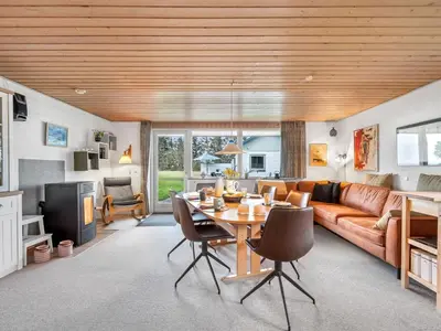 a living room with a couch and a table at Holiday Home Moreen - 200m to the fjord by Interhome in Vemb