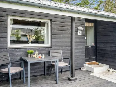 a patio with a table and chairs on a deck at Holiday Home Jukka - 2km from the sea by Interhome in Snedsted