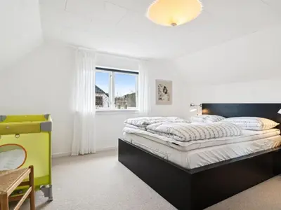 a bedroom with a bed and a window at Holiday Home Birtir - 750m from the sea by Interhome in Hanstholm