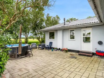 a patio with a pool table and chairs at Holiday Home Elara - 300m from the sea by Interhome in Thyholm