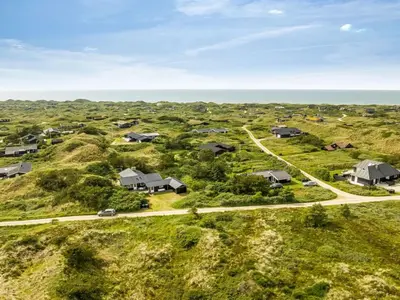 an aerial view of homes on a hill next to the ocean at Holiday Home Selenia - 1km from the sea by Interhome in Saltum
