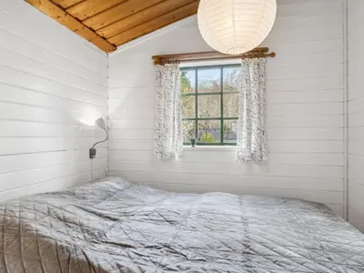 a bedroom with a bed and a window at Holiday Home Bonde - 800m to the fjord by Interhome in Farsø