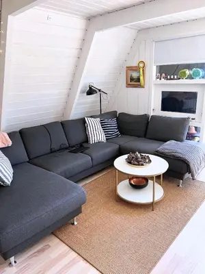 a living room with a couch and a table at Hyggeligt golfhus i Himmerland in Farsø