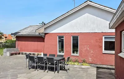 a table and chairs in front of a red building at Lovely Home In Vestervig With Kitchen in Vestervig