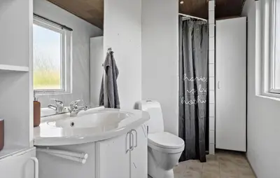 a white bathroom with a sink and a toilet at Lovely Home In Vestervig With Kitchen in Vestervig