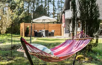 a hammock in a yard with an umbrella at 2 Bedroom Gorgeous Home In Saltum in Saltum