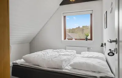 a white bed in a room with a window at Pet Friendly Home In Lemvig With Wifi in Lemvig