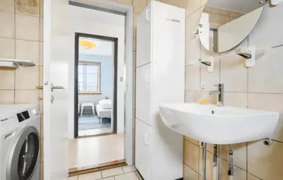 a bathroom with a sink and a washing machine at 3 Bedroom Pet Friendly Home In Frøstrup in Frøstrup