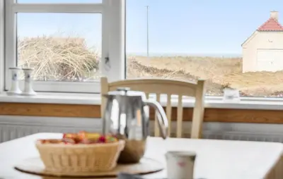 a kitchen table with a juicer and a basket of fruit at 3 Bedroom Pet Friendly Home In Frøstrup in Frøstrup