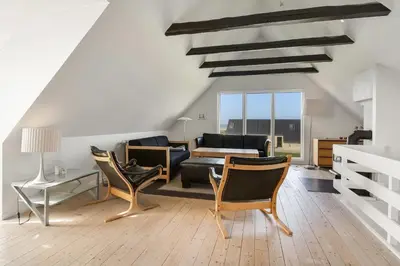 a living room with a couch and chairs and a table at Pool house with beautiful view by the sea - SJ650 in Lemvig