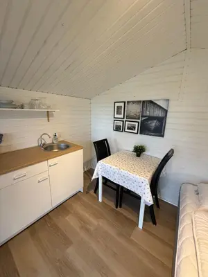 a small kitchen with a table and a sink at Himmerland camping & Feriecenter in Års