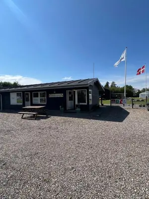a building with two flags in front of it at Himmerland camping & Feriecenter in Års