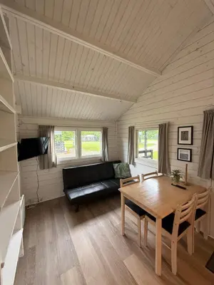a living room with a couch and a table at Himmerland camping & Feriecenter in Års
