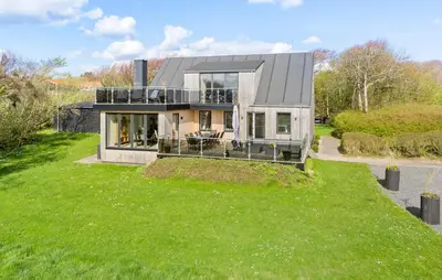 a house on a hill with a green yard at Stunning Home In Spøttrup With Wifi in Spottrup