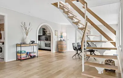 a white living room with a staircase and a table at Stunning Home In Spøttrup With Wifi in Spottrup