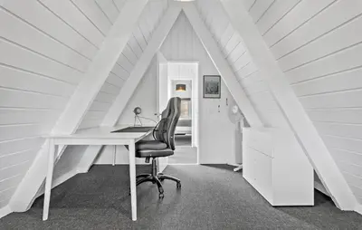 an attic office with a desk and a chair at Awesome Home In Farsø With Wifi in Farsø