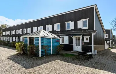 a black building with a greenhouse in front of it at Amazing Apartment In Vestervig in Vestervig