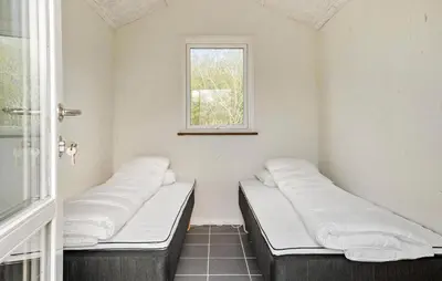 two beds in a room with a window at 4 Bedroom Nice Home In Vinderup in Vinderup
