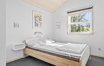 a bed in a white room with a window at 3 Bedroom Amazing Home In Vestervig in Vestervig