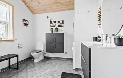 a bathroom with a toilet and a sink at 3 Bedroom Amazing Home In Vestervig in Vestervig
