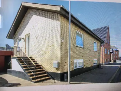 a brick building with stairs on the side of it at Nyd den skønne natur ved hav og fjord in Thyborøn