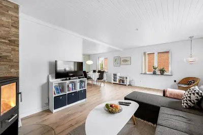 a living room with a couch and a table at Nyd den skønne natur ved hav og fjord in Thyborøn