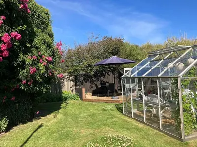 a garden with a gazebo and a patio at Nyd den skønne natur ved hav og fjord in Thyborøn