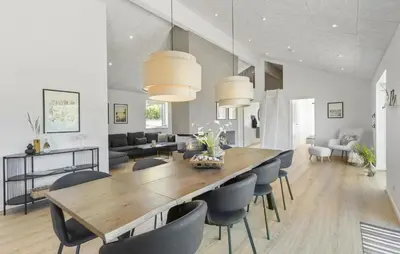 a dining room and living room with a table and chairs at Gorgeous Home In Saltum With Sauna in Saltum