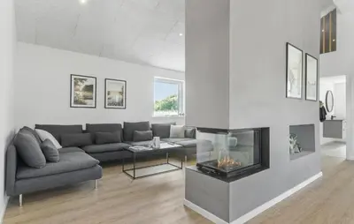 a living room with a couch and a fireplace at Gorgeous Home In Saltum With Sauna in Saltum