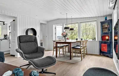 a kitchen and dining room with a table and chairs at 2 Bedroom Awesome Home In Højslev in Højslev