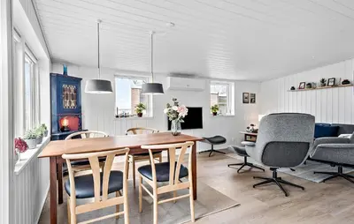 a kitchen and dining room with a table and chairs at 2 Bedroom Awesome Home In Højslev in Højslev