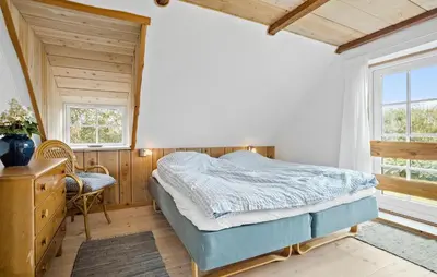 a bedroom with a bed and a desk and windows at 4 Bedroom Cozy Home In Vestervig in Vestervig