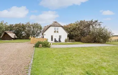 a white house with a fence and a yard at 4 Bedroom Cozy Home In Vestervig in Vestervig