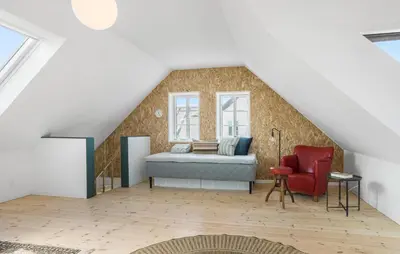 a bedroom with a bed and a red chair at Lovely Home In Thisted With Wifi in Thisted