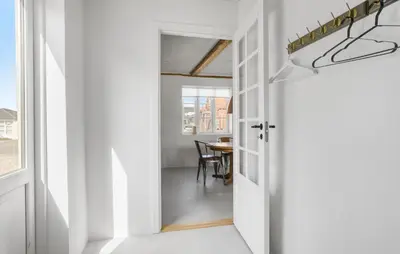 a hallway leading to a dining room with a table at Lovely Home In Thisted With Wifi in Thisted