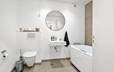 a bathroom with a sink and a toilet and a mirror at Stunning Home In Roslev With Kitchen in Roslev