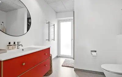 a bathroom with a red dresser and a mirror at Stunning Home In Roslev With Kitchen in Roslev