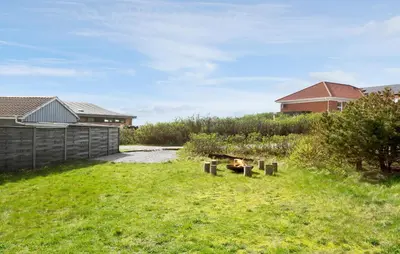 a backyard with a fire pit in the grass at Lovely Home In Thisted With Sauna in Thisted