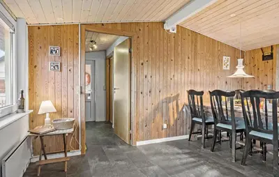 a dining room with wooden walls and a table and chairs at Gorgeous Home In Thisted in Thisted