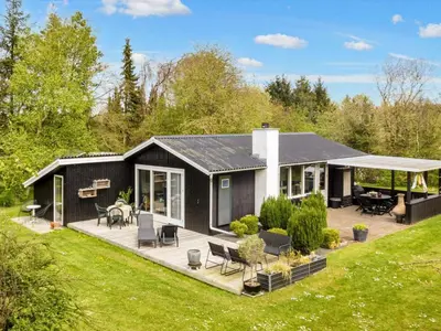 a black and white house with a patio at 6 person holiday home in Farsø-By Traum in Farsø