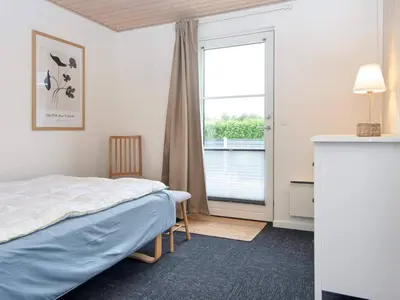 a bedroom with a bed and a large window at 5 star holiday home in Vinderup-By Traum in Vinderup