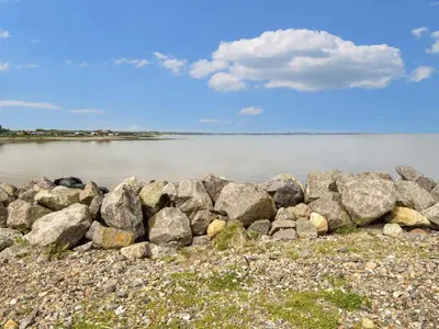 a group of rocks on the shore of a body of water at 5 star holiday home in Vinderup-By Traum in Vinderup