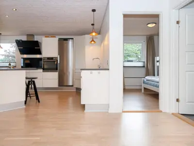 a kitchen with white cabinets and a counter top at 5 star holiday home in Vinderup-By Traum in Vinderup
