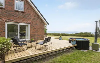 a wooden deck with chairs and a hot tub at 3 Bedroom Beautiful Home In Vesløs in Vesløs